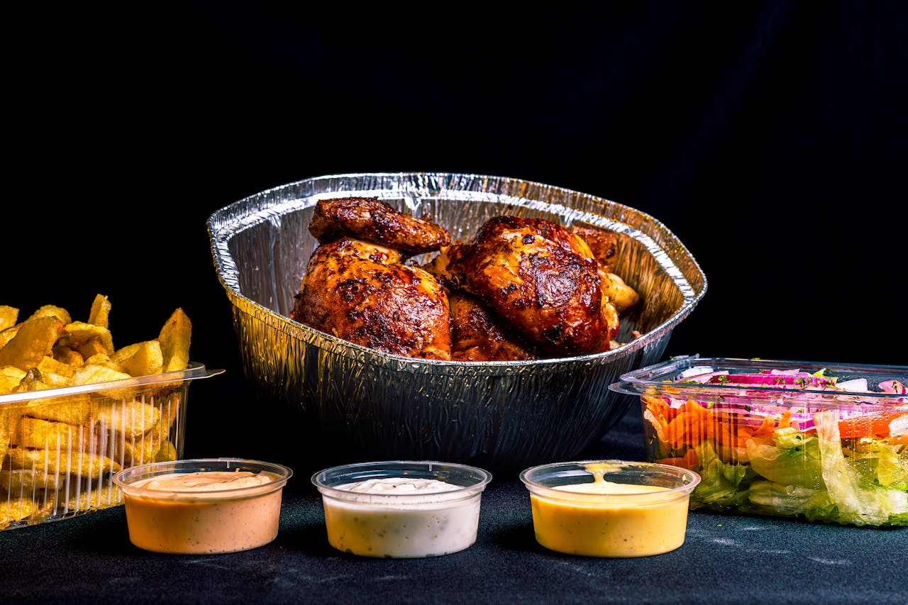 our-services-3 Roast chicken served with sauces, fries, and salad, perfect for a hearty meal.